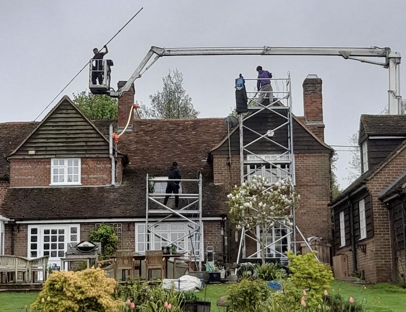 The Moss Cleaners using cherry picker and scaffolding to clean roof safely and professionally in Blackfield, Hampshire